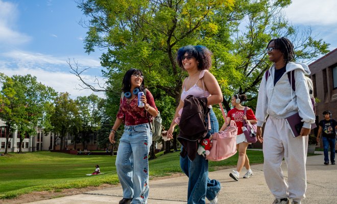 three students walking on campus