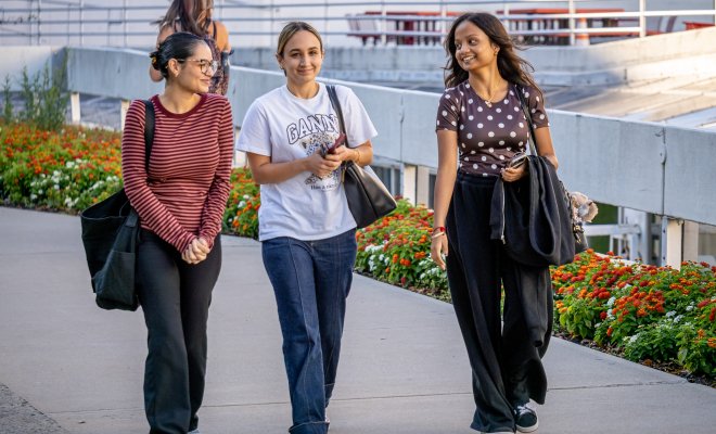 three students walking on campus