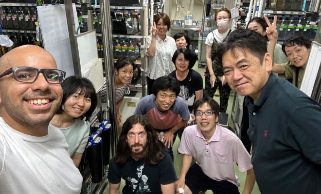 student selfie with group in their lab
