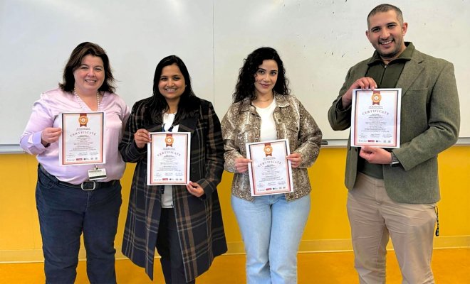 Student team with mentor Dr. Kathy Herbert holding their IEMTRONICS awards