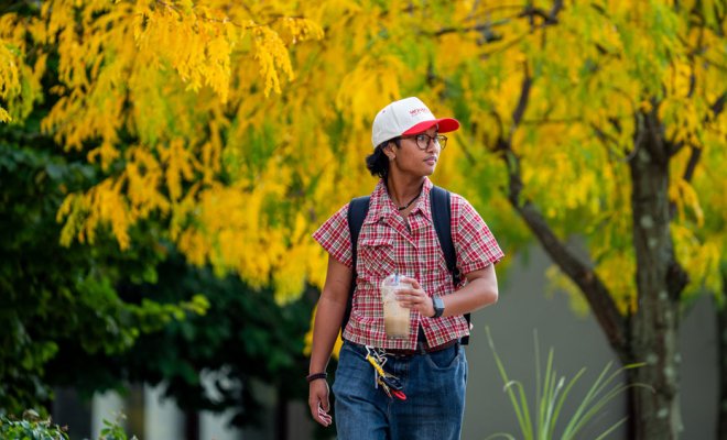 student walking around campus