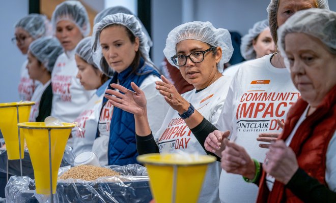 Montclair volunteers get ready to pack up food for children with Rise Against Hunger during Community Impact Day.