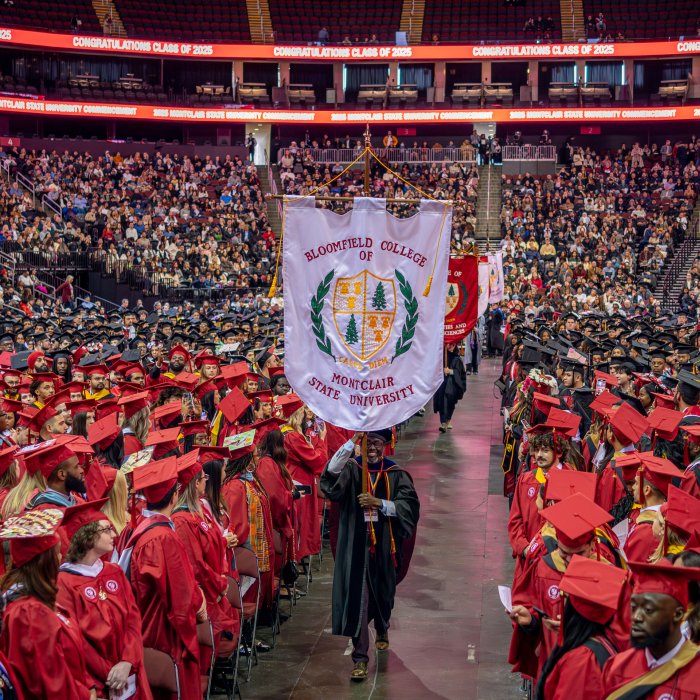 Nixon Cleophat carries the Bloomfield College of Montclair State University flag during the Academic Processional.