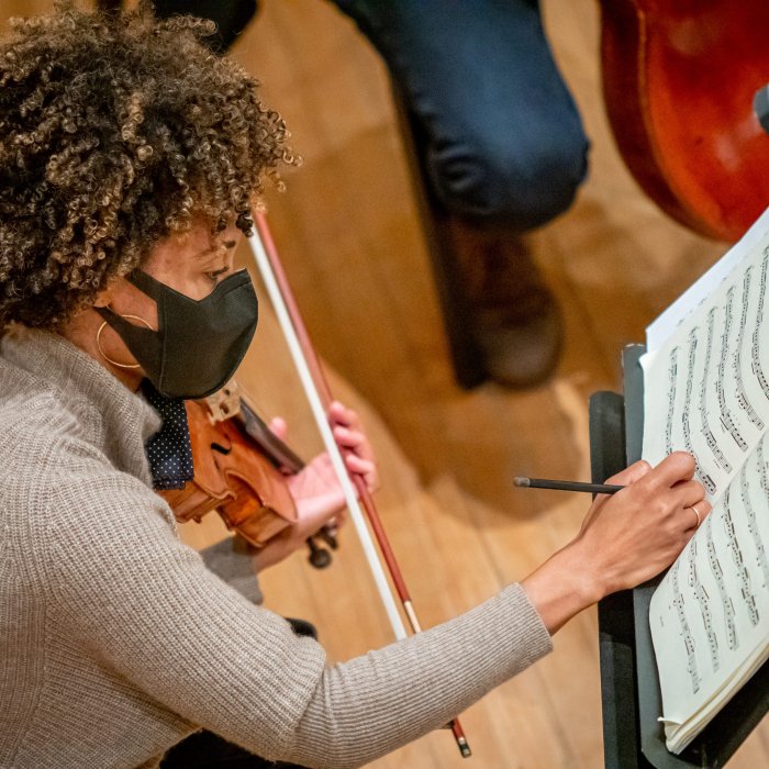 Woman is writing on a score sheet.