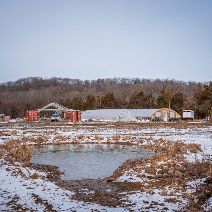 Farm with snow on land.