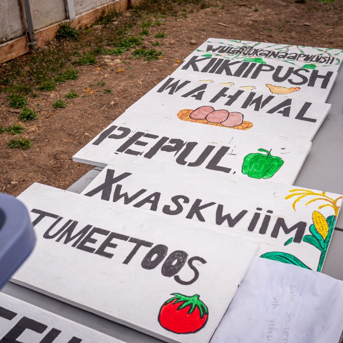 Signs for garden written in Native American language.