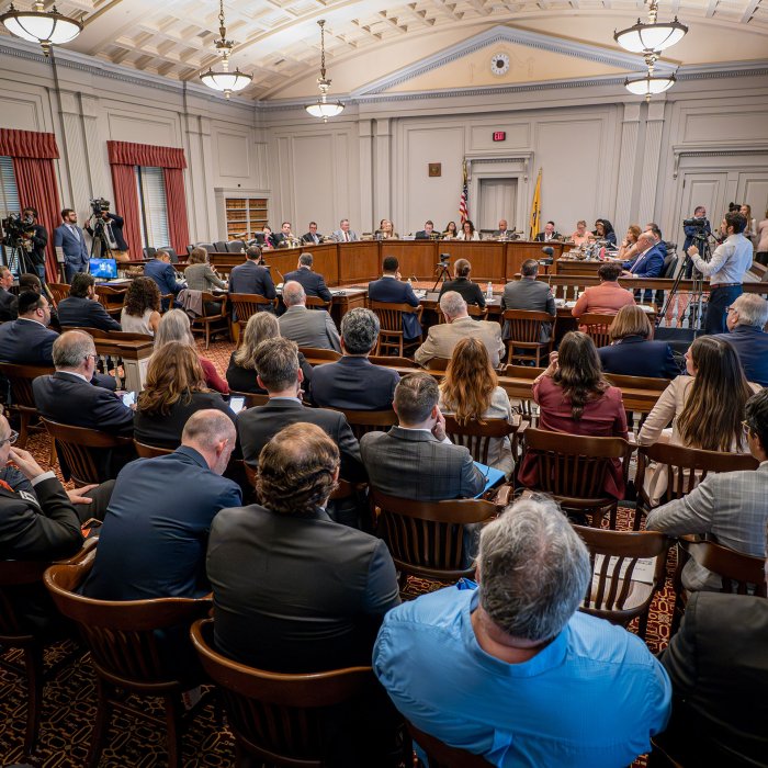 A packed hearing room.