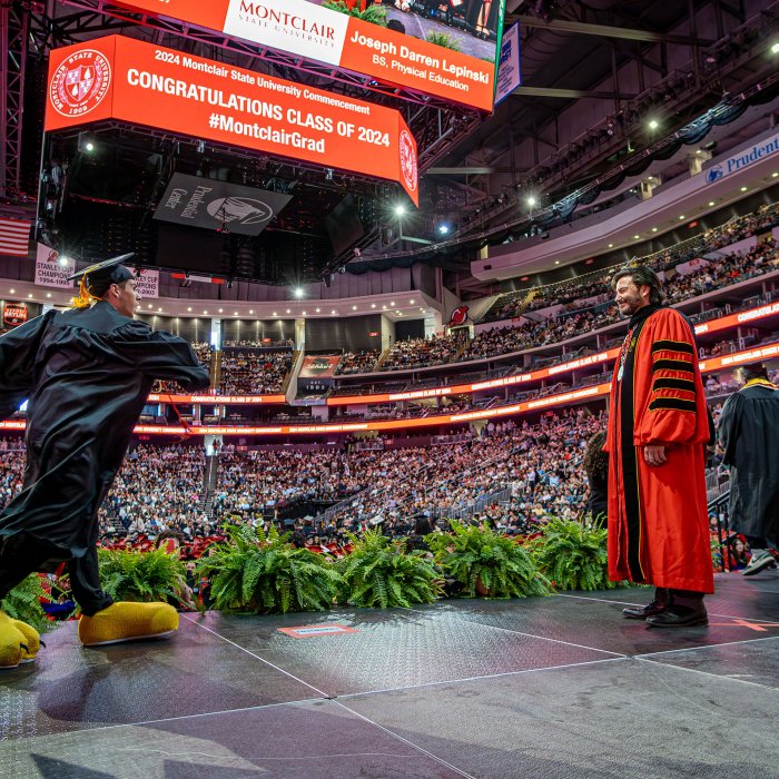'Jersey Joe' walks across the stage wearing the yellow talon slippers that reveal the graduates who have been on Team Rocky