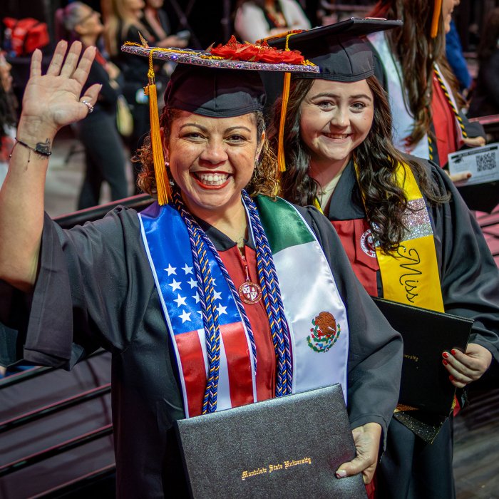 Iliana Woodhull smiles with her degree
