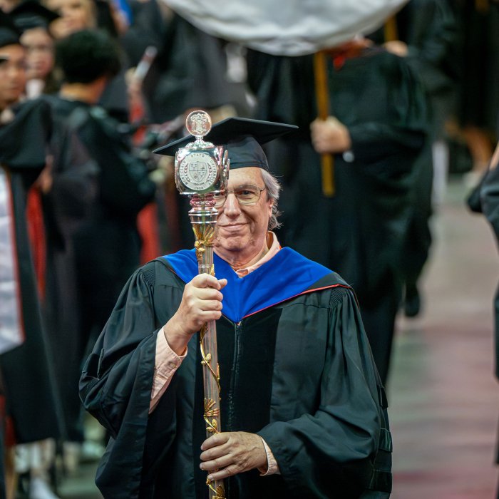 Grand Marshal Rich Wolfson carrying the University mace