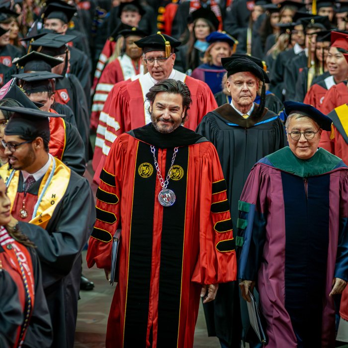 President Koppell and Provost Junius Gonzales walking toward the stage