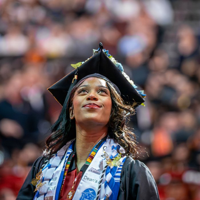A graduating member of Zeta Phi Beta Sorority, Inc. looks upward