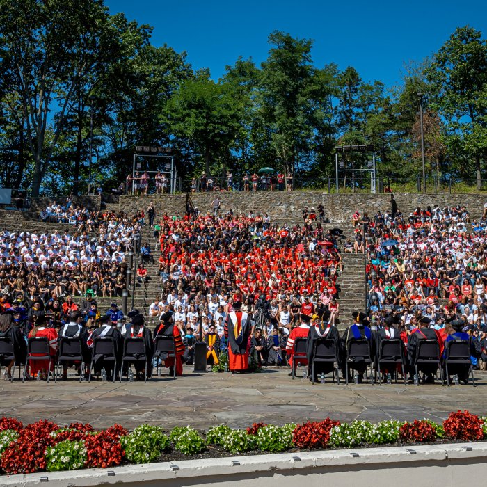 attendees seated in amphitheater on campus