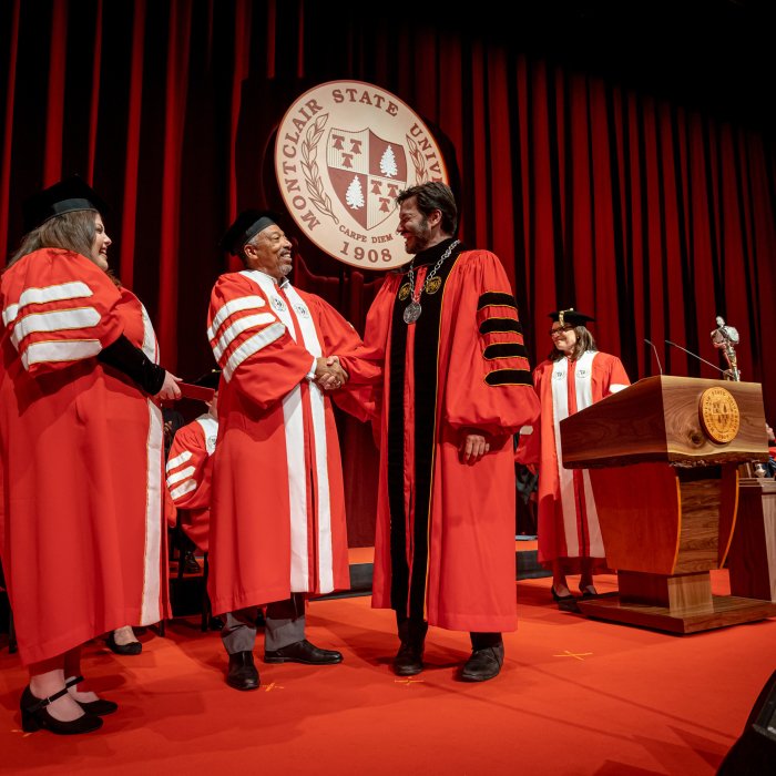 President Koppell shakes Trustee Preston Pinkett's hand