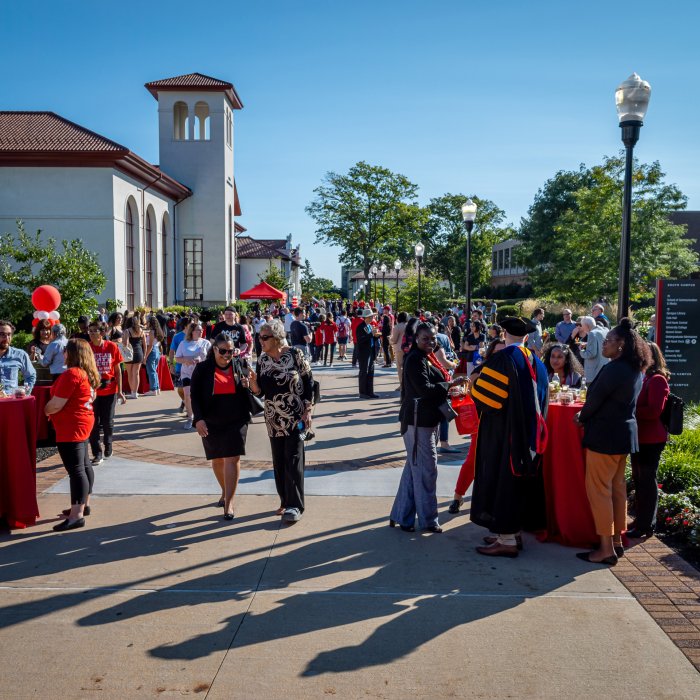 Attendees on campus at various tables