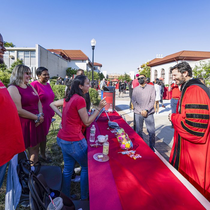 President Koppell talking with students over table