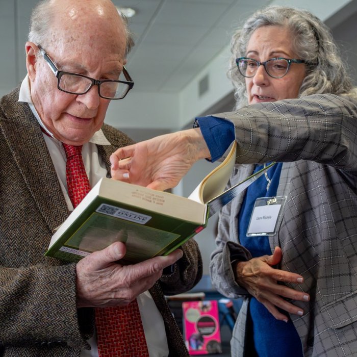 man and woman looking at book