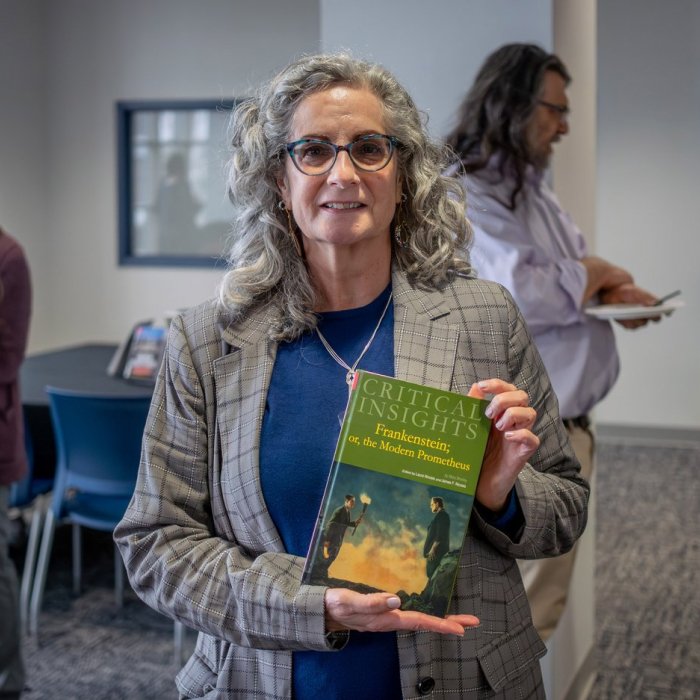 author holding a book
