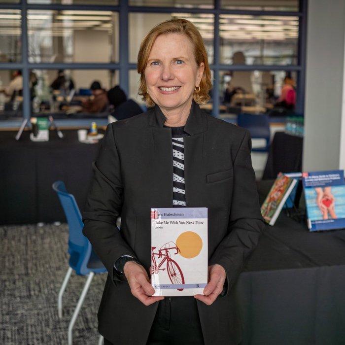 author holding a book