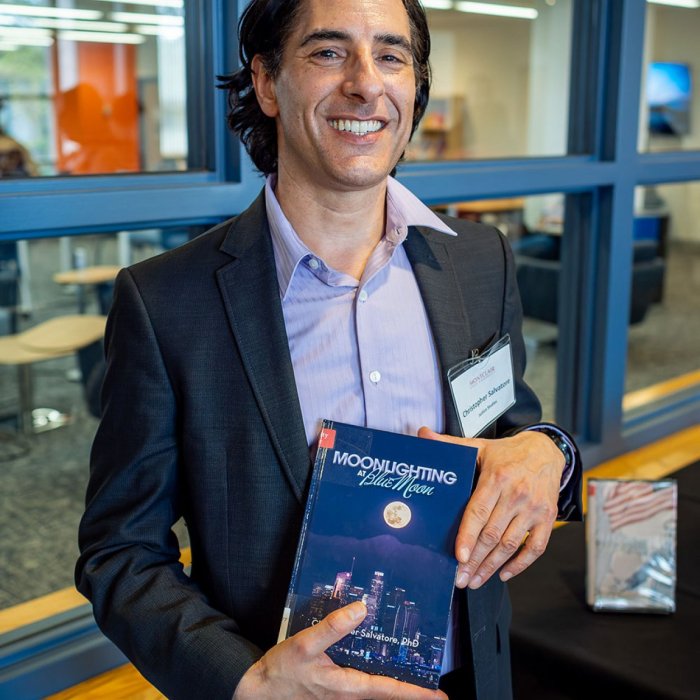 author holding book