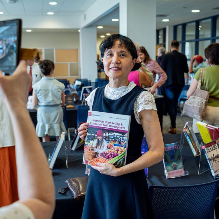 author holding book