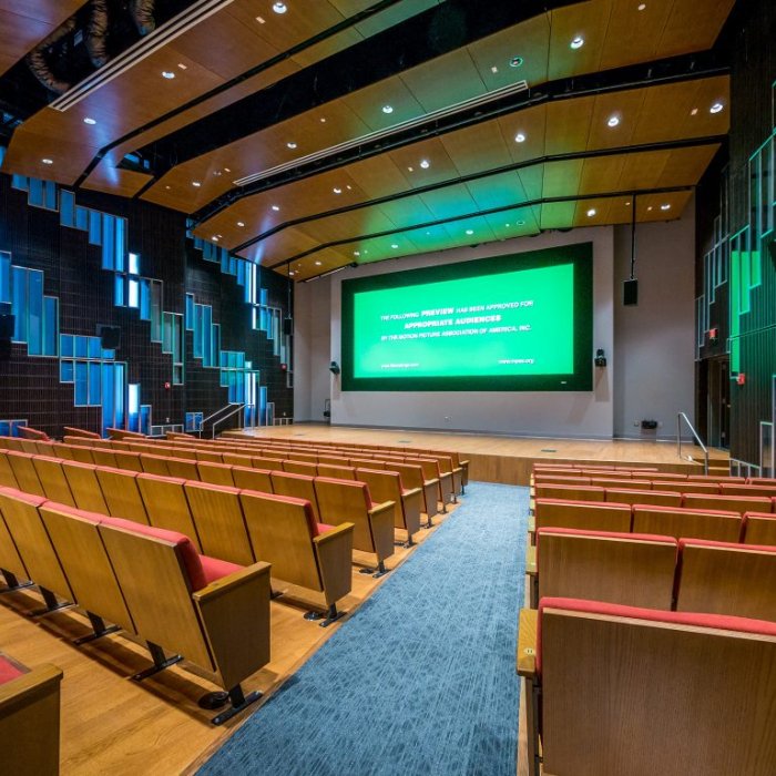 Presentation Hall in the SCM Building looking at the stage with a green screen for location scouting