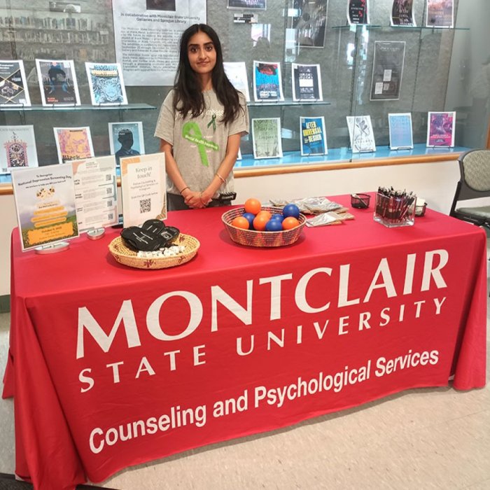 student at CAPs table in from of exhibit