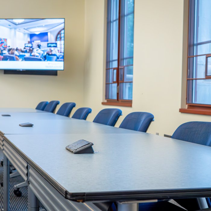Empty classroom table with chairs lined up 