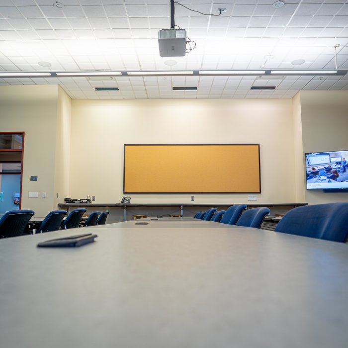 Empty classroom with board on wall 