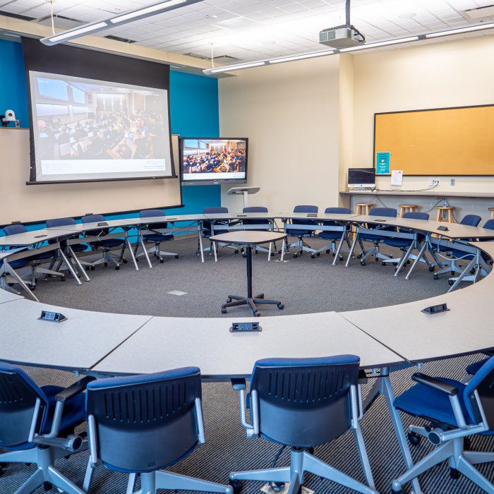 Empty round table in center of open classroom 