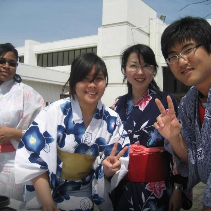A group of four college student wear kimonos and pose for the camera