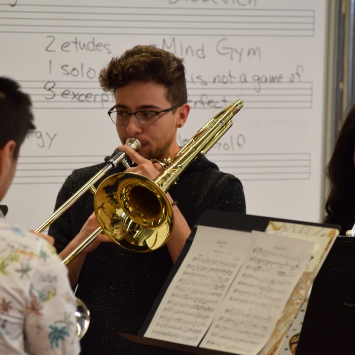 Trombone and trumpet students in rehearsal