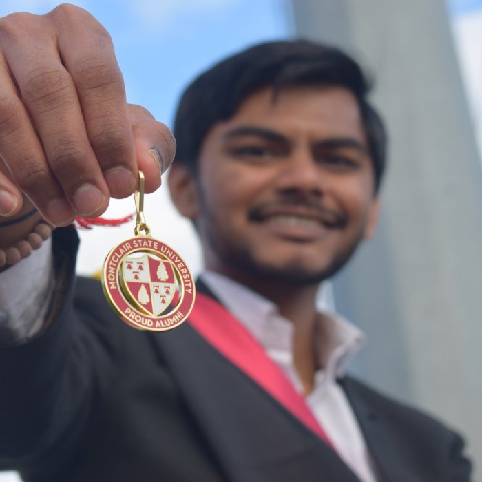 A picture of a student holding a Montclair alumni keychain.
