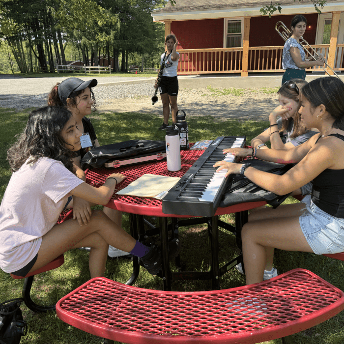 stokes campers playing keyboard on picnic table