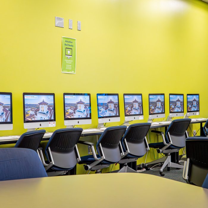 Wall of computer lab lined with computers 