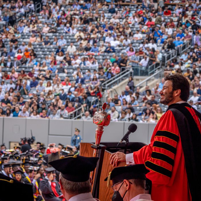 President Koppell at the podium during 2022 commencement ceremony at MetLife Stadium