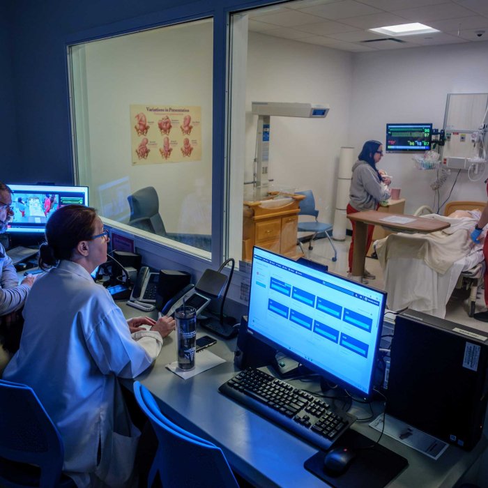 Montclair State University School of Nursing students with a training dummy in the maternity simulation lab.