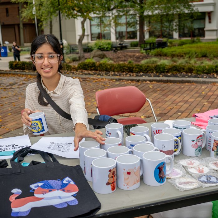 Student vendor at an outdoor Creators' Marketplace