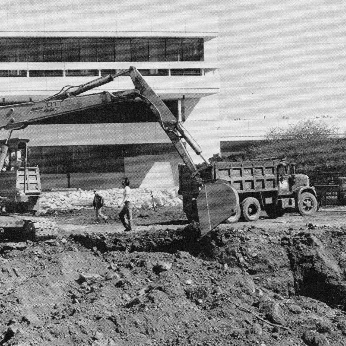 Backhoe digging the construction site of the Student Center Annex in 1980