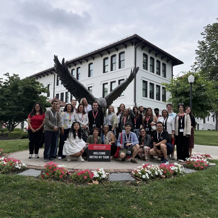 A picture of a group of counselors standing in front of the Red Hawk statue for the 2026 Metro New York Counselor Tour