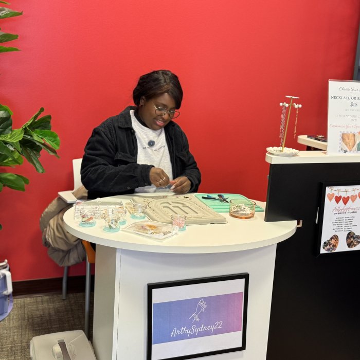 A student vendor creates new merchandise at Creators' Corner