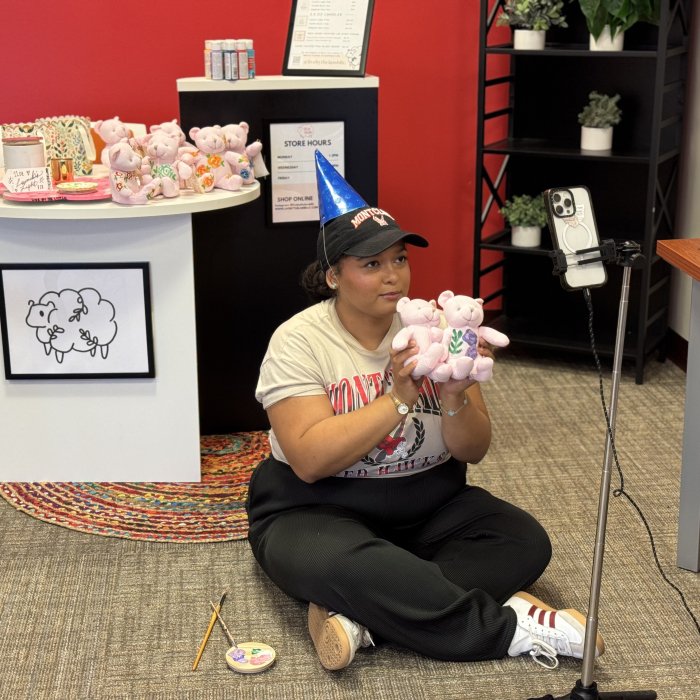 A student vendor livestreams from Creators' Corner
