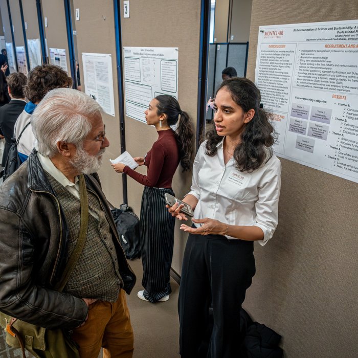 Student presenting research to professor