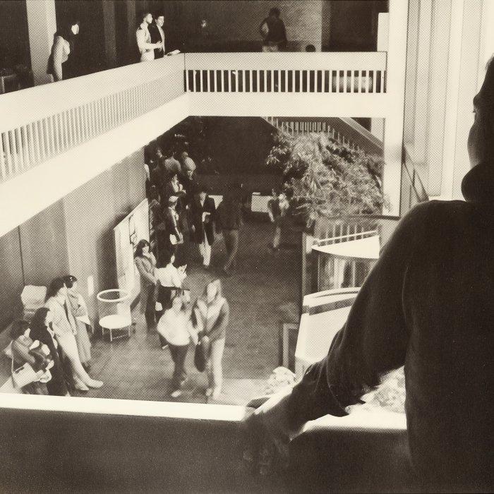 Student overlooking Student Center lobby 1980