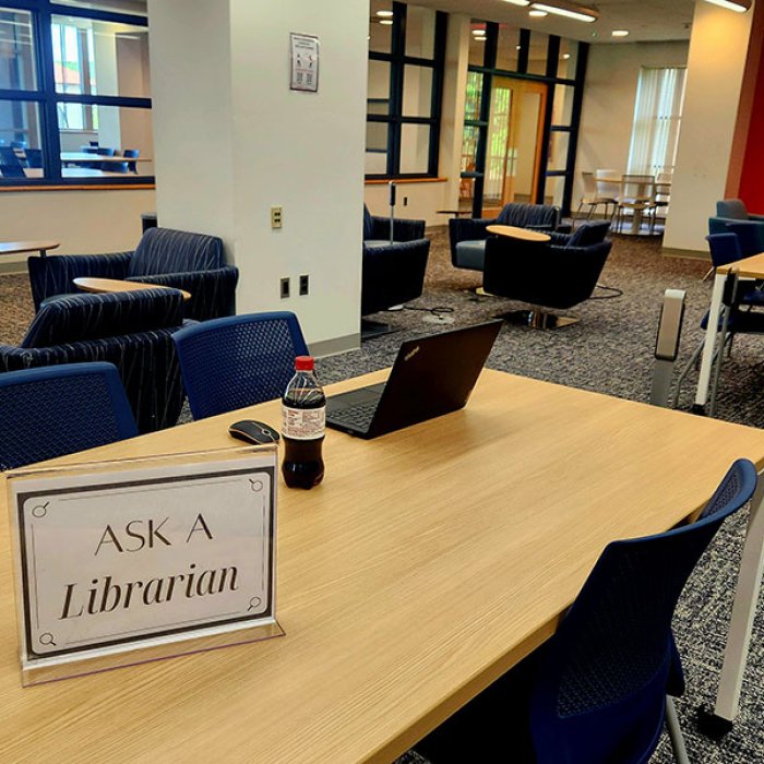 a table with a sign that says ask a librarian