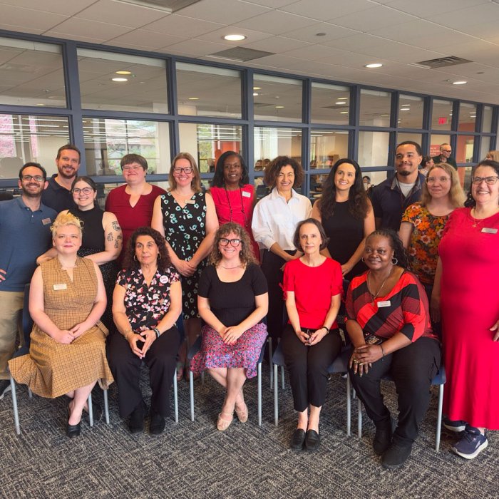 group photo of library employees and Interim Provost Mili