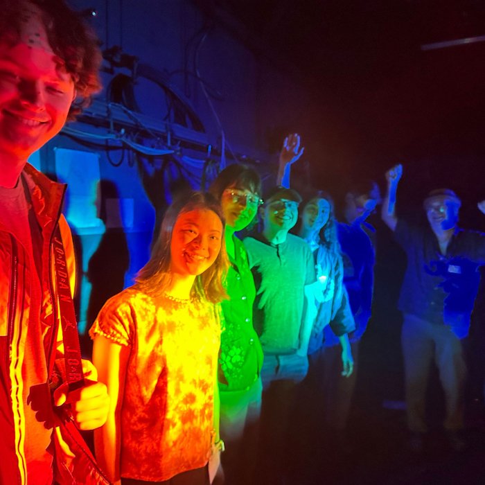 students in rainbow light
