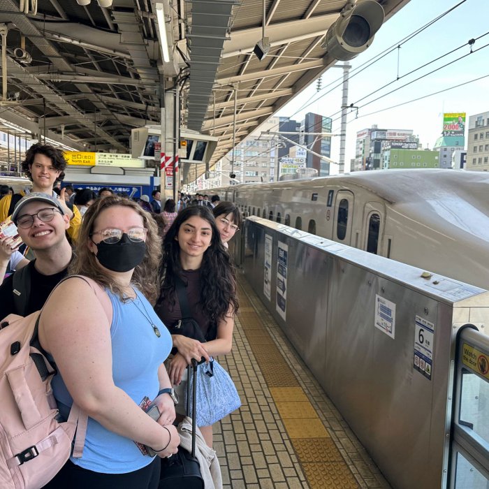 students waiting to board a train in Japan