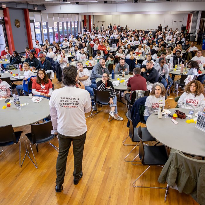 President Jonathan Koppell speaks with Montclair empolyee volunteers.