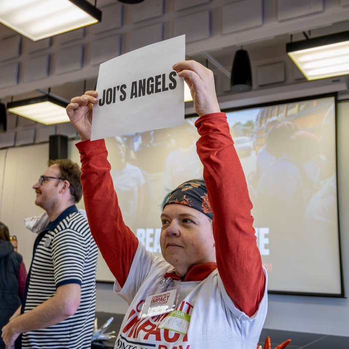 A Montclair employee holds up a sign for Joi's Angels.